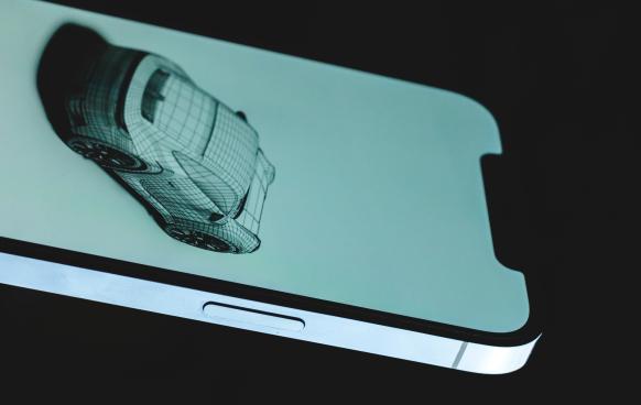 photo of an iphone screen displaying a 3d wireframe model of a sports car.